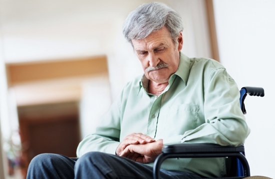 Sad old man sitting on a wheelchair in the hospital